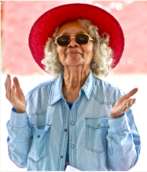 Older woman wearing sunglasses and hat Primghar Dentist